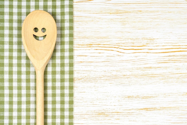 Kitchen mockup Wooden spoon with smile on white wooden background Food background with copy space