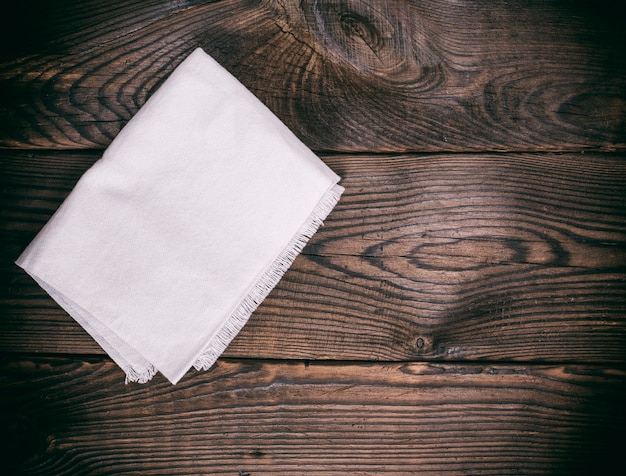 Foto tovagliolo di cucina su un fondo di legno marrone