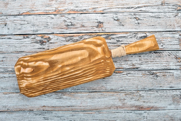 Kitchen old wooden board On a white wooden background Free space for text Top view