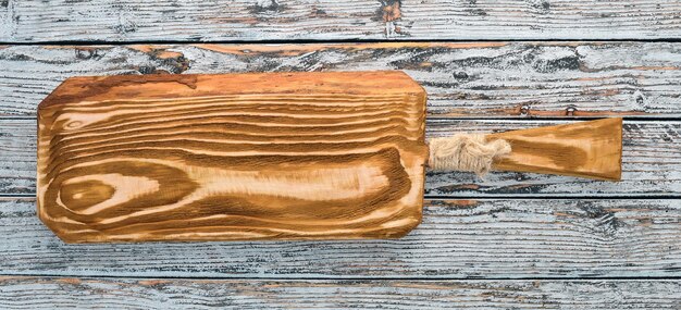 Kitchen old wooden board On a white wooden background Free space for text Top view