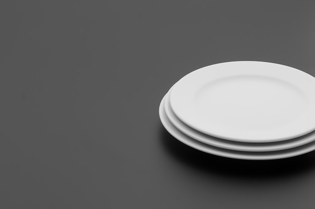 kitchen and restaurant utensils, plates, on a dark background