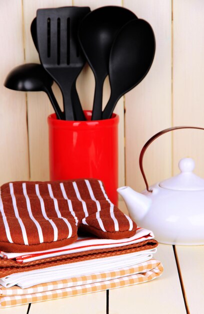 Kitchen settings utensil potholders towels and else on wooden table