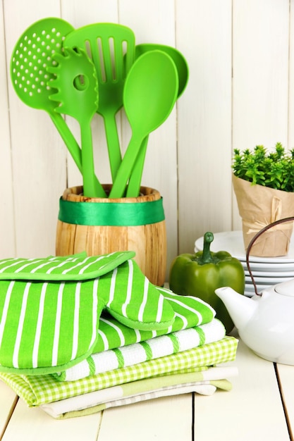 Kitchen settings utensil potholders towels and else on wooden table