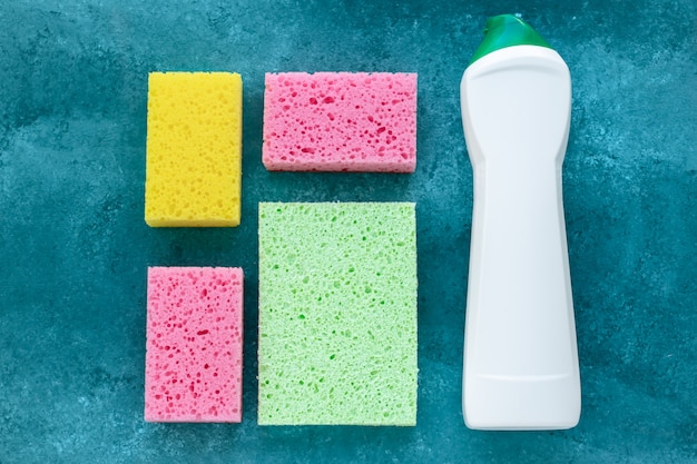 Kitchen sponges and antibacterial cleaner in bottle, disinfection concept. Housekeeping, housework. Colorful sponges for washing dishes and cleaning