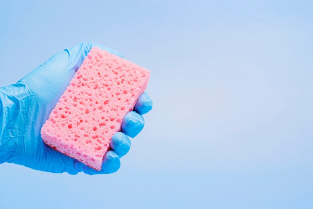 Kitchen sponges in hand.