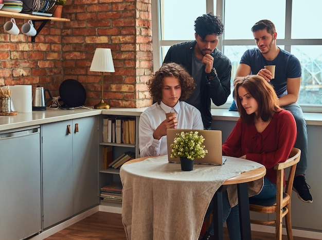 Kitchen in the student dormitory. Group of interracial students engaged in education.