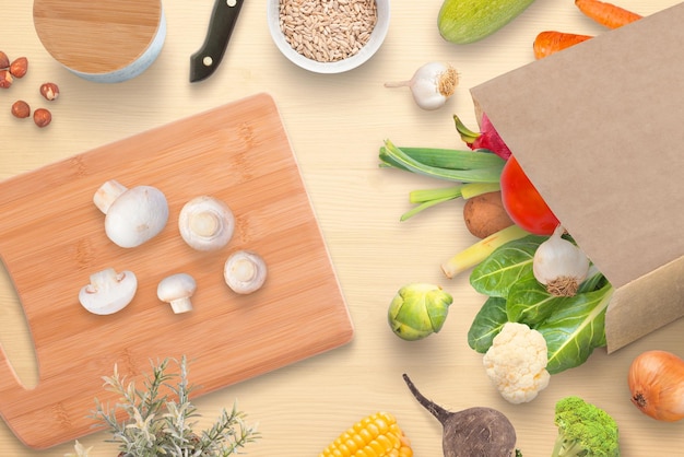 Kitchen table with cutting board mushrooms spices and fresh vegetables from city market