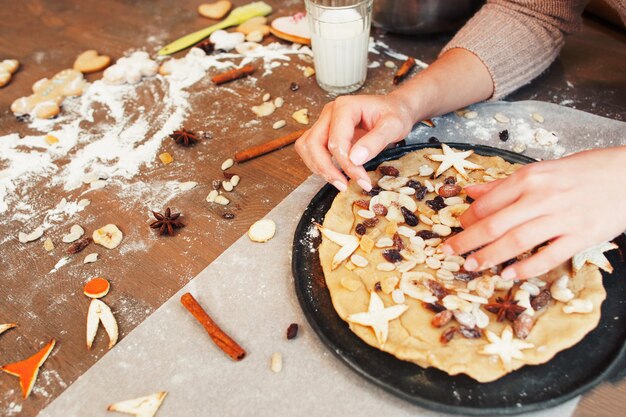 Kitchen table with dried fruits pie preparing