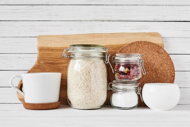 Kitchen tools and cutting board on white table