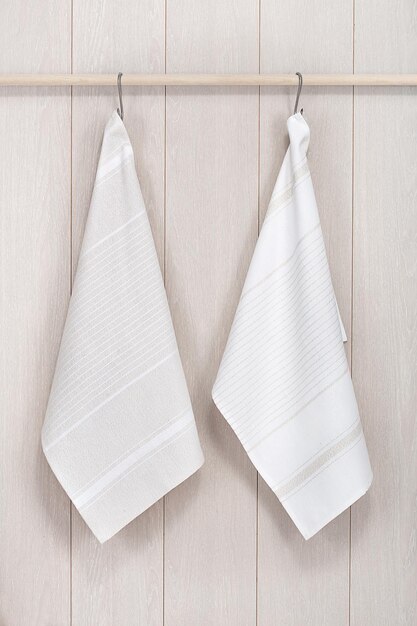 Kitchen towels hanging on wooden background