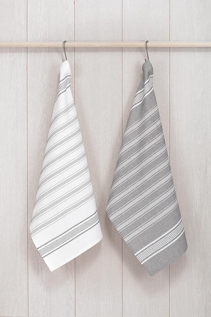 Kitchen towels hanging on wooden background
