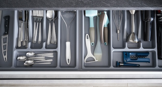 Kitchen utensils in drawer, top view.