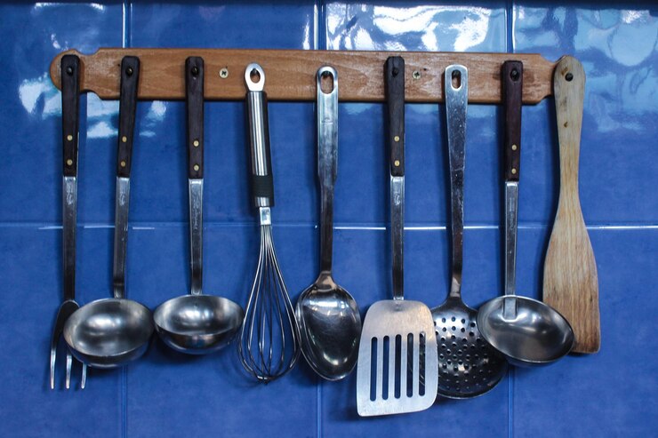 फोटो kitchen utensils hanging on wall at home