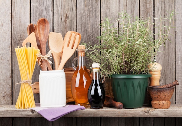 Kitchen utensils herbs and spices on shelf