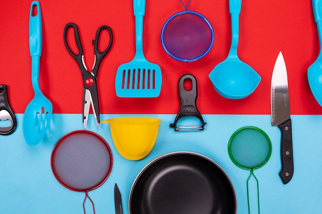 Kitchen utensils isolated on red-blue 