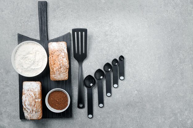 Kitchen utensils and products on grey background Cooking master classes