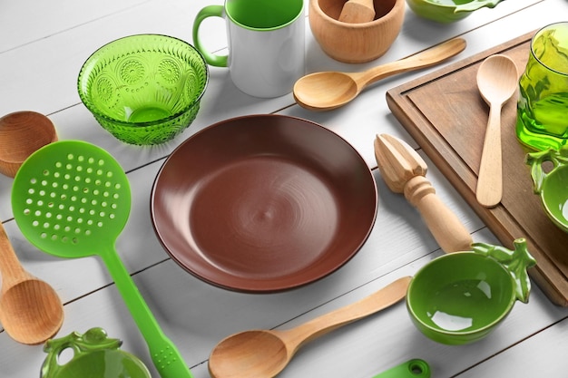 Kitchen utensils and tableware on wooden table