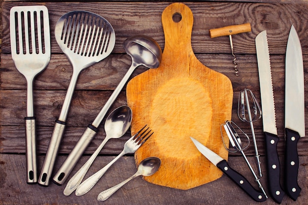 kitchen utensils on wooden background.