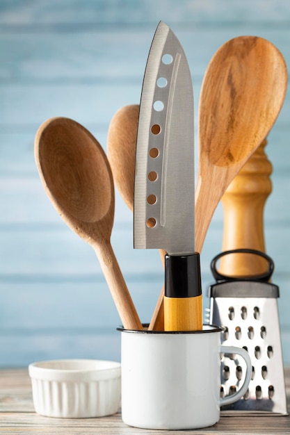 Kitchen utensils on wooden background