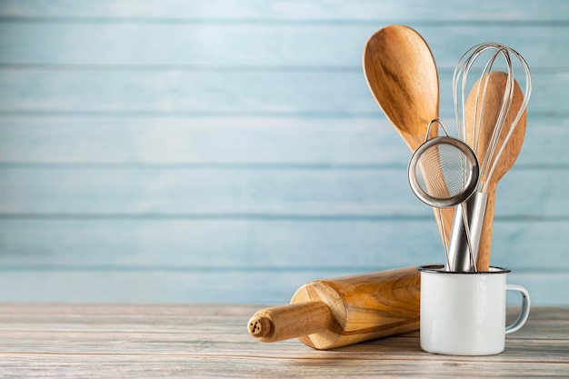 Kitchen utensils on wooden background