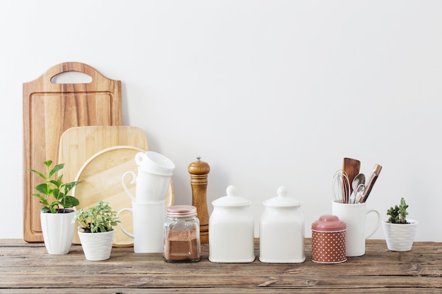 Kitchen utensils on wooden table in white kitchen