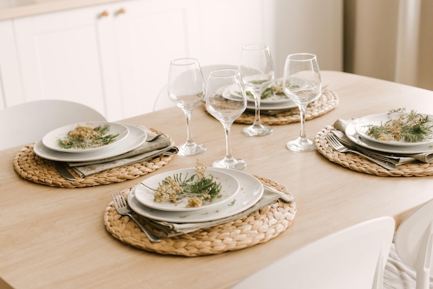 Kitchen white wooden kitchen with Scandinavianstyle dining area decorated with mimosa