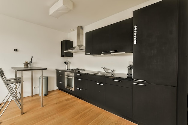 A kitchen with black cabinetry and a counter top