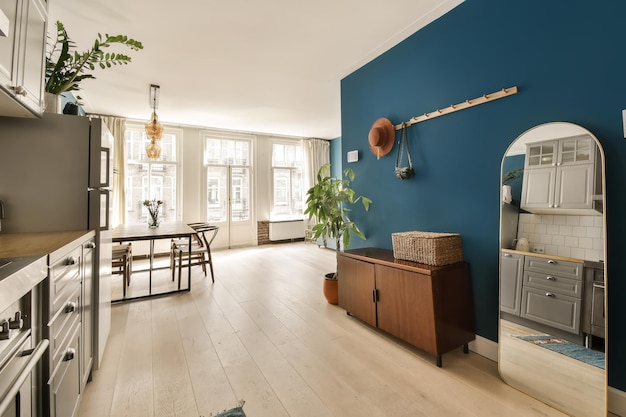 A kitchen with a blue wall and a wooden floor