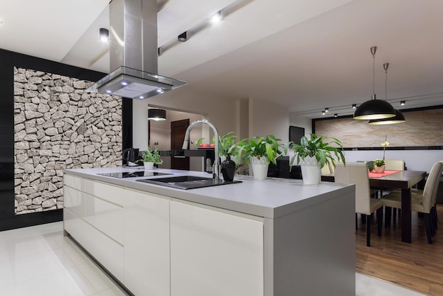 A kitchen with a large island with a stove and a stove.