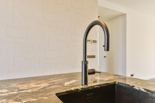 A kitchen with a sink and a faucet