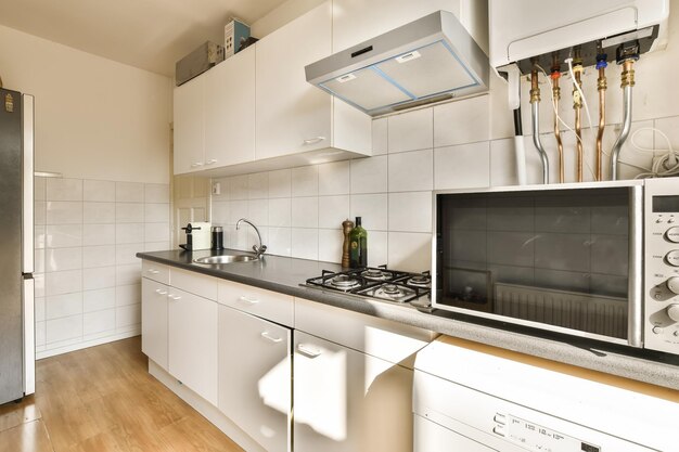 a kitchen with a stove top oven and a sink