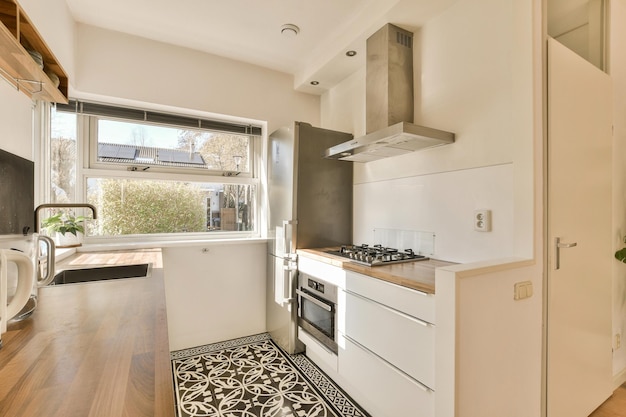 A kitchen with a stove and a window