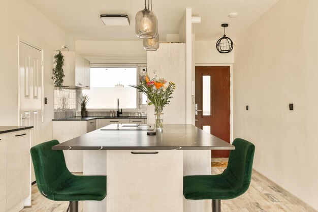 a kitchen with a table and green chairs