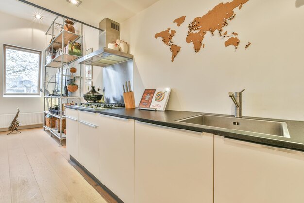 A kitchen with white cabinets and a sink and counter