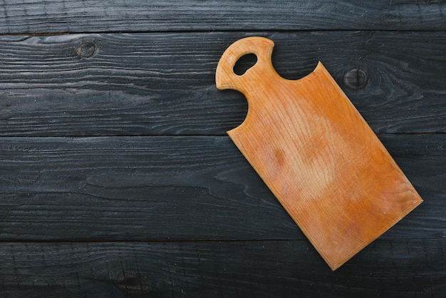 Kitchen wooden board On a wooden background Top view Free space for your text