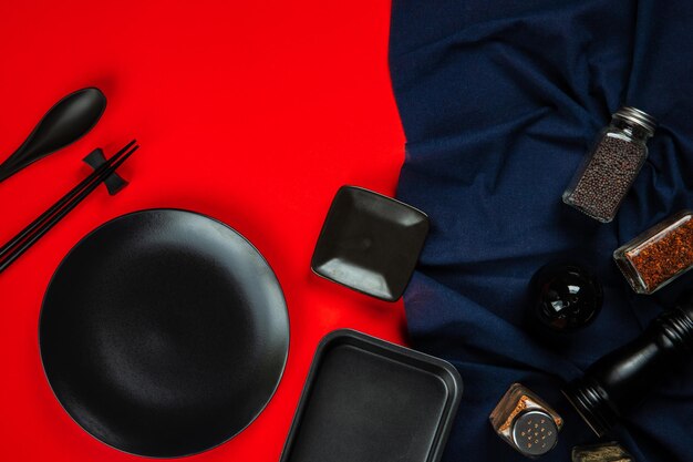 Photo kitchenware set with tablecloth on red background