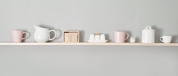 Kitchenware on wooden shelves. Kitchen interior background.Opened cupboard with kitchenware inside.