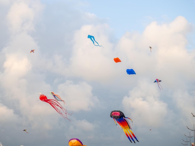 A kite in the sky Upwards Wind Kite Festival Colorful toys People fly kites Holiday at the resort