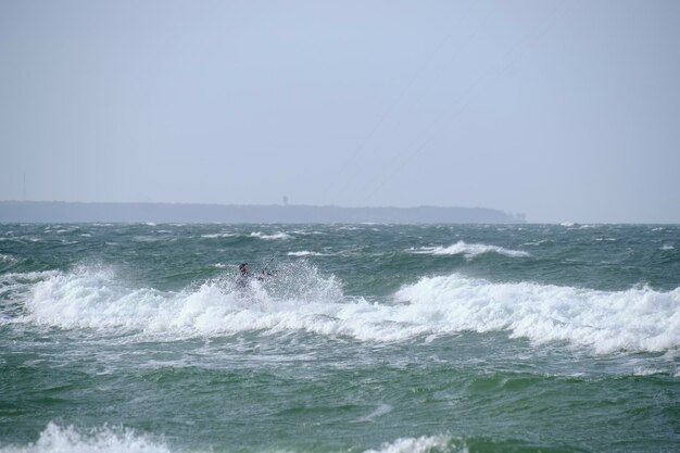 Kitesurfing in the sea during a storm and big waves