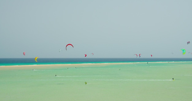 Kitesurfing on the tropical beach of Playa Del Mal Nombre Fuerteventura Canary Islands Spain Azure