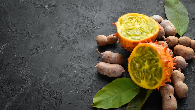 Kiwano on a black background. Tropical Fruits. Top view. Free space for text.