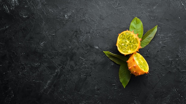 Kiwano on a black background Tropical Fruits Top view Free space for text