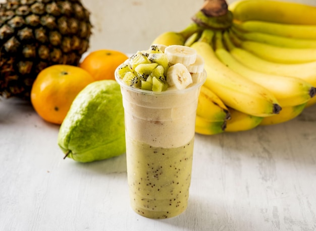 Premium Photo | Kiwi banana milkshake served in disposable glass ...