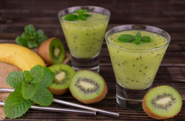 Kiwi and banana smoothie on a gray background Closeup