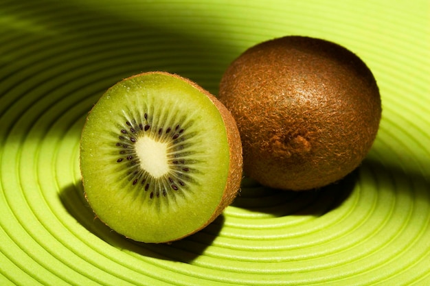 A kiwi cut in half showing the seeds