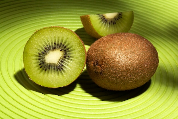 A kiwi cut in half showing the seeds