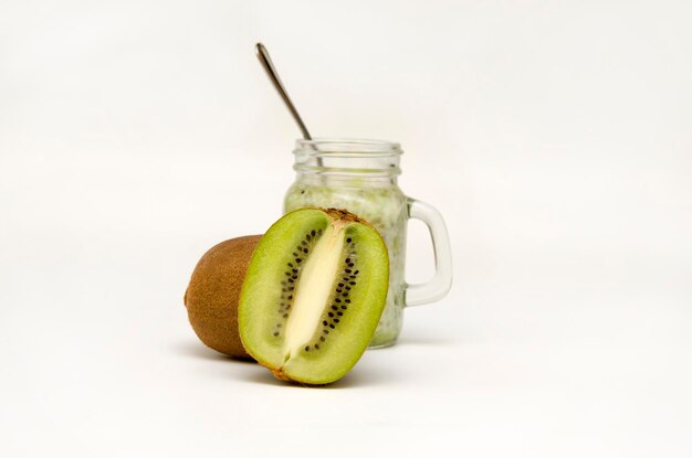 Kiwi cutaway and smoothie bottle on a white background