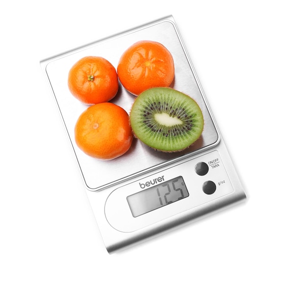 Kiwi en mandarijnen op digitale keukenweegschaal geïsoleerd op wit