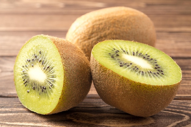 Kiwi fruit half cut on wooden background