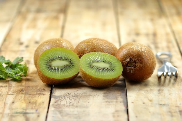 Kiwi fruit slice on plank wood. 